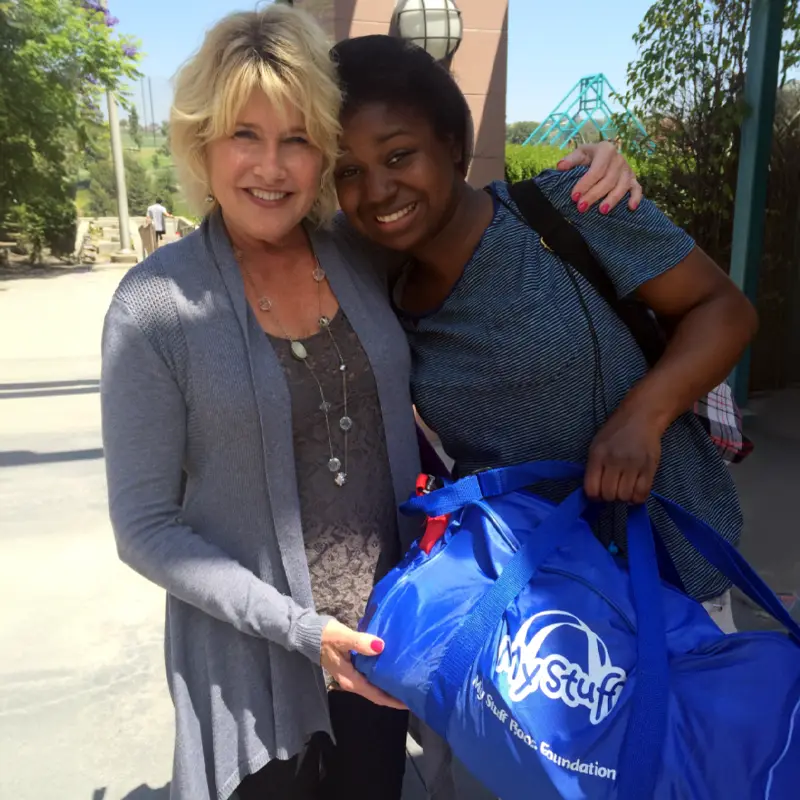 My Stuff Bags CEO Hugging a My Stuff Bag Recipient