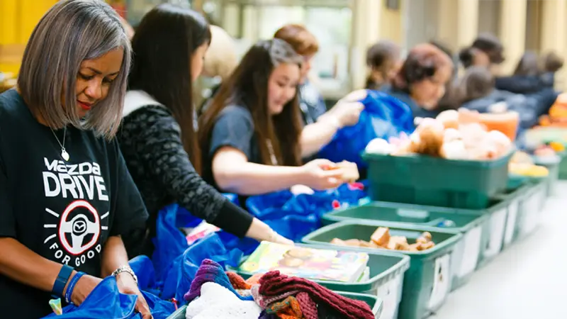 Group of Volunteers Stuffing Bags