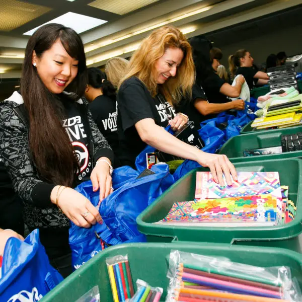 Two Volunteers Packing a My Stuff Bag