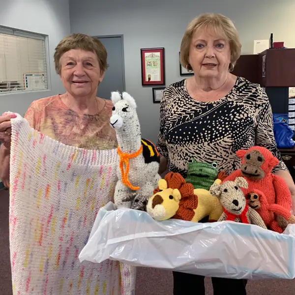 Two Volunteers Delivering Handmade Crafts to My Stuff Bags