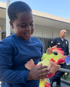 smiling boy with stuffede animal dragons and beasties
